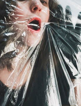 Woman suffocating behind plastic