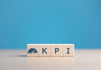 Wooden cubes with a KPI word and icons. Key Performance Indicator (KPI), business goals,...