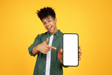 Positive black guy showing smartphone with white blank screen