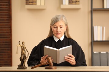Obraz premium Judge reading book at wooden table indoors