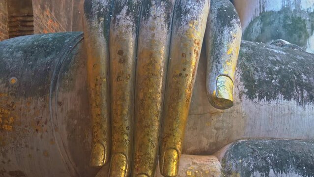 The most beautiful finger of Buddha.
Finger of Phra Ajana, The Big Buddha Statue At Wat Si Chum, Sukhothai Historical Park.
Golden finger of Pra Ajana Talking Buddha Statue Sukhothai Thailand. 
