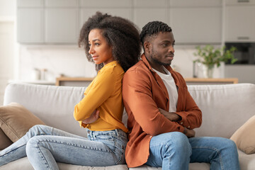 Frustrated African American Couple Sulking After Quarrel In Living Room