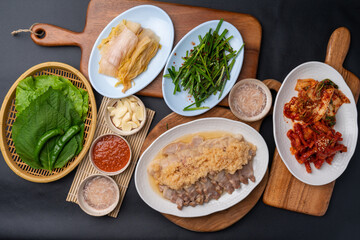 Korean food, bossam, boiled pork, pig feet, steamed pork feet, side dishes, lettuce, garlic bossam, perilla leaves, chives, kimchi
