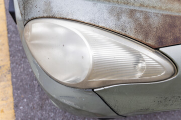 Hazy opaque foggy front head lamp of car reduces light pass-through and driving visibility