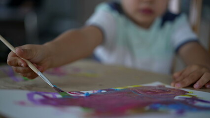 Obraz premium Closeup of Child's Hand Painting with Watercolor and Brush