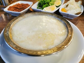 A plate of national Turkish ishkembe soup in a plate on the table with snacks for the soup