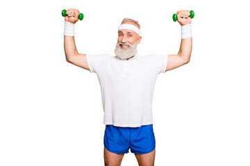Naklejka premium Body care, hobby, weight loss lifestyle. Cheerful cool grandpa with humor grimace exercising holding equipment up, lifts it with strength and power, wearing blue sexy shorts, so hot!
