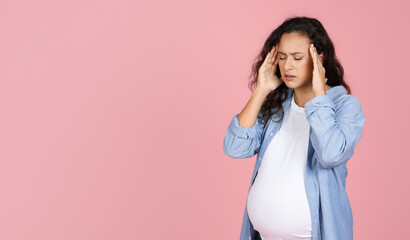 Young pregnant woman suffering from headache or migraine