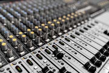 Obraz premium Mixer control. Music engineer. Backstage controls on an audio mixer, Sound mixer. Professional audio mixing console with lights, buttons, faders and sliders. sound check for concert. 