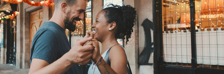 Happy interracial couple dancing outdoors, Panorama - obrazy, fototapety, plakaty