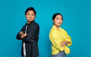 Stern-faced man and woman with arms crossed, showing a defiant or confrontational attitude
