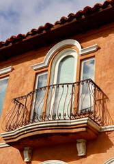 Mediterranean style building with decorative railing on the balcony