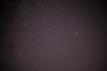 Meteor shower during perseid curent. Andromeda galaxy in the night sky