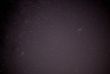 Meteor shower during perseid curent. Andromeda galaxy in the night sky