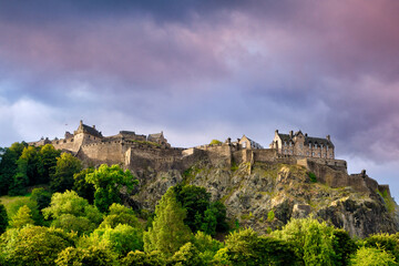 Fototapeta na wymiar Edinburgh Castle, perched on its rock above the trees on Princes Street Gardens.