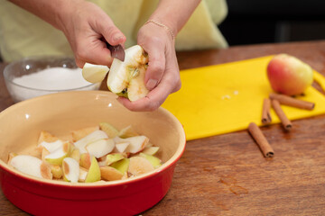 Hands cutting apples with a knife. Cooking apple pie.