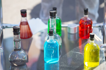 Transparent laboratory flask with multi-colored liquid or chemical solution.