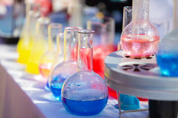 Transparent laboratory flask with multi-colored liquid or chemical solution.
