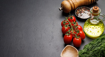 Cooking scene: Cherry tomatoes, herbs and spices on table