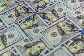 Many 100 USD banknotes set with heads of Benjamin Franklin one to another 