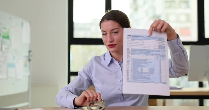 Strict tax inspector with form 1040 and handcuffs in office
