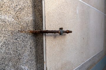 old rusted gas pipe with a knob on the side