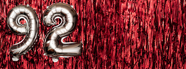 Silver foil balloon number ninety-two. Birthday or anniversary card with the inscription 92. red...