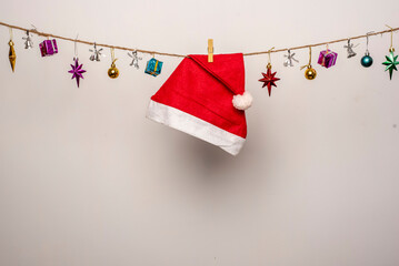 Santa hat and gifts are hanging on isolate white background