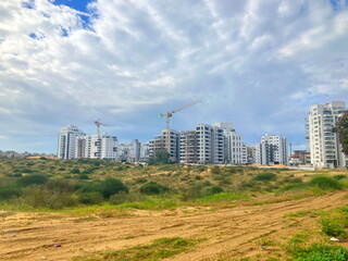 Fototapeta na wymiar Construction in the desert. Panorama of a large residential complex construction. Israeli new buildings. Real estate in the Middle East