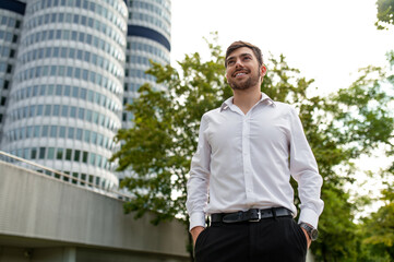 Young dark-haired man in white shirt smiling a d feeling joyful