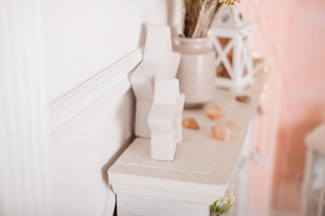 A minimalist Scandinavian-inspired shelf with decorative objects in a neutral color palette.