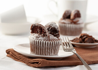 Chocolate muffins filled with jam in the shape of a butterfly.