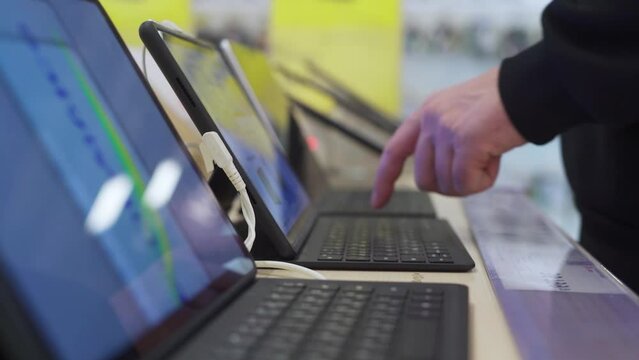 Buyer checking laptops in a computer store