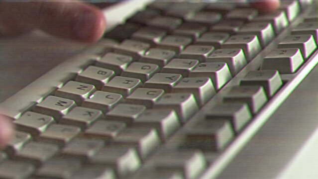 Computer engineer developer is working on old vintage computer 1990s. Antique classic pc keyboard and programmer typing hands. Internet web digital startup history. Outdated retro technology concept