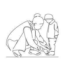 mother ties the lace on her child's shoe