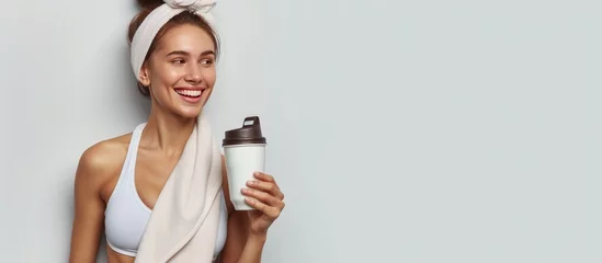 Foto op Plexiglas Portrait happy young woman in sportswear, white towel, holding healthy drink after gym. AI generated © MUCHIB