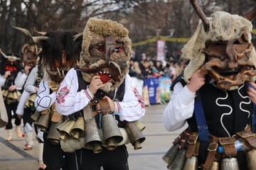 Pernik, Bulgaria - January 27, 2024: The 30th International masquerade festival Surva in Pernik, Bulgaria. People with mask called Kukeri dance and perform to scare the evil spirits. - obrazy, fototapety, plakaty