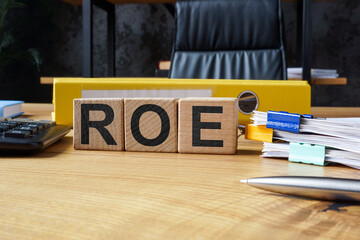 Office desk and cubes with ROE Return on Equity.