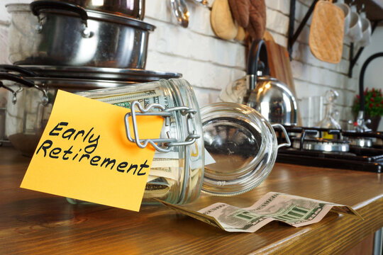 Early retirement concept. Glass jar with money on the home table.