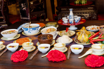 Tet tray. Full of traditional dishes. Chinese new year festival table with asian food. Vietnamese food for Tet holiday in lunar new year. Text on food meaning happy and peaceful.