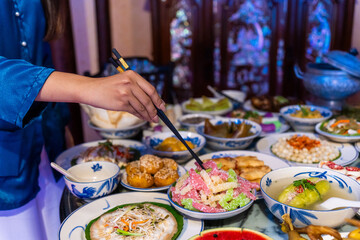 Tet tray. Full of traditional dishes. Chinese new year festival table with asian food. Vietnamese food for Tet holiday in lunar new year. Text on food meaning happy and peaceful.