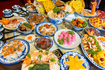 Tet tray. Full of traditional dishes. Chinese new year festival table with asian food. Vietnamese food for Tet holiday in lunar new year. Text on food meaning happy and peaceful.