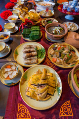 Tet tray. Full of traditional dishes. Chinese new year festival table with asian food. Vietnamese food for Tet holiday in lunar new year. Text on food meaning happy and peaceful.