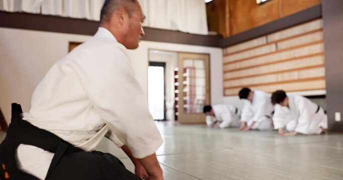 Martial arts students, master or bow in dojo for aikido practice, discipline or self defense in class. Respect, floor or Japanese master teaching combat or training workout for fighting or education