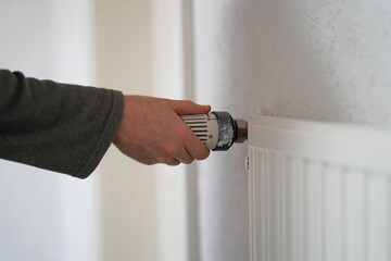 Hand turning up the radiator for heating an old house