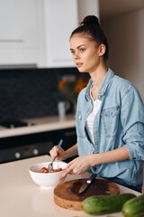 Healthy Lifestyle: Young Caucasian Woman, Happy and Content, Preparing Fresh Vegetarian Salad in a Kitchen