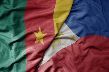 Fototapeta premium big waving national colorful flag of philippines and national flag of cameroon .