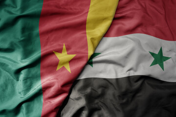 big waving national colorful flag of syria and national flag of cameroon .