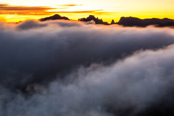 Fototapeta premium Mountains peaks at sunrise above fog in Madeira