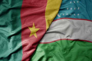 big waving national colorful flag of uzbekistan and national flag of cameroon .